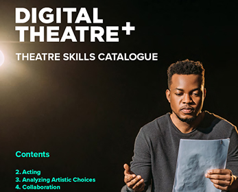 A young person sits in a spotlight on a stage, delivering lines from a script.