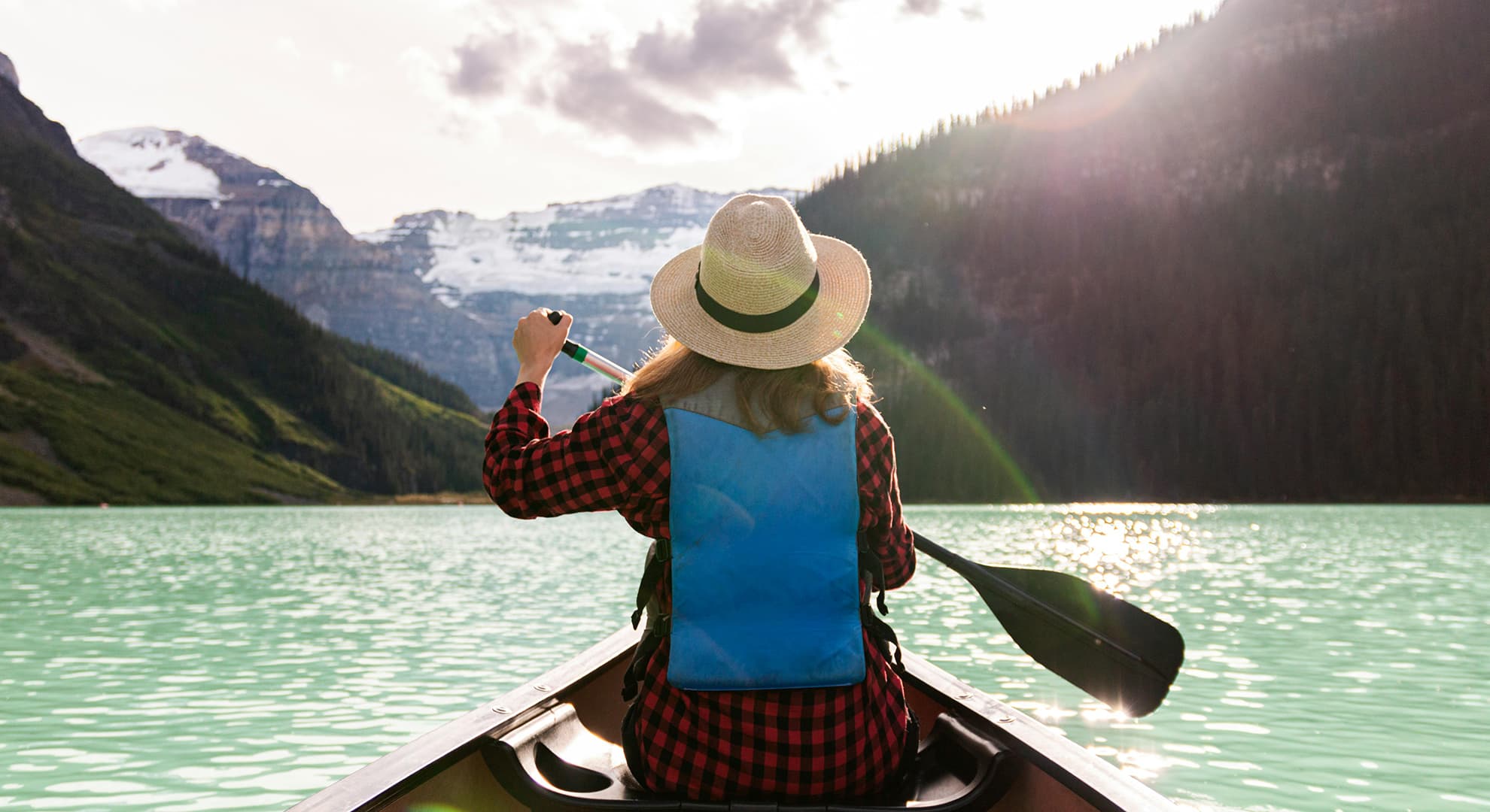 Woman on a kayak on a river.