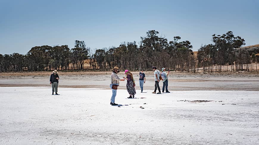 A group of people standing on a salt flat