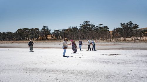 A group standing on a salt flat