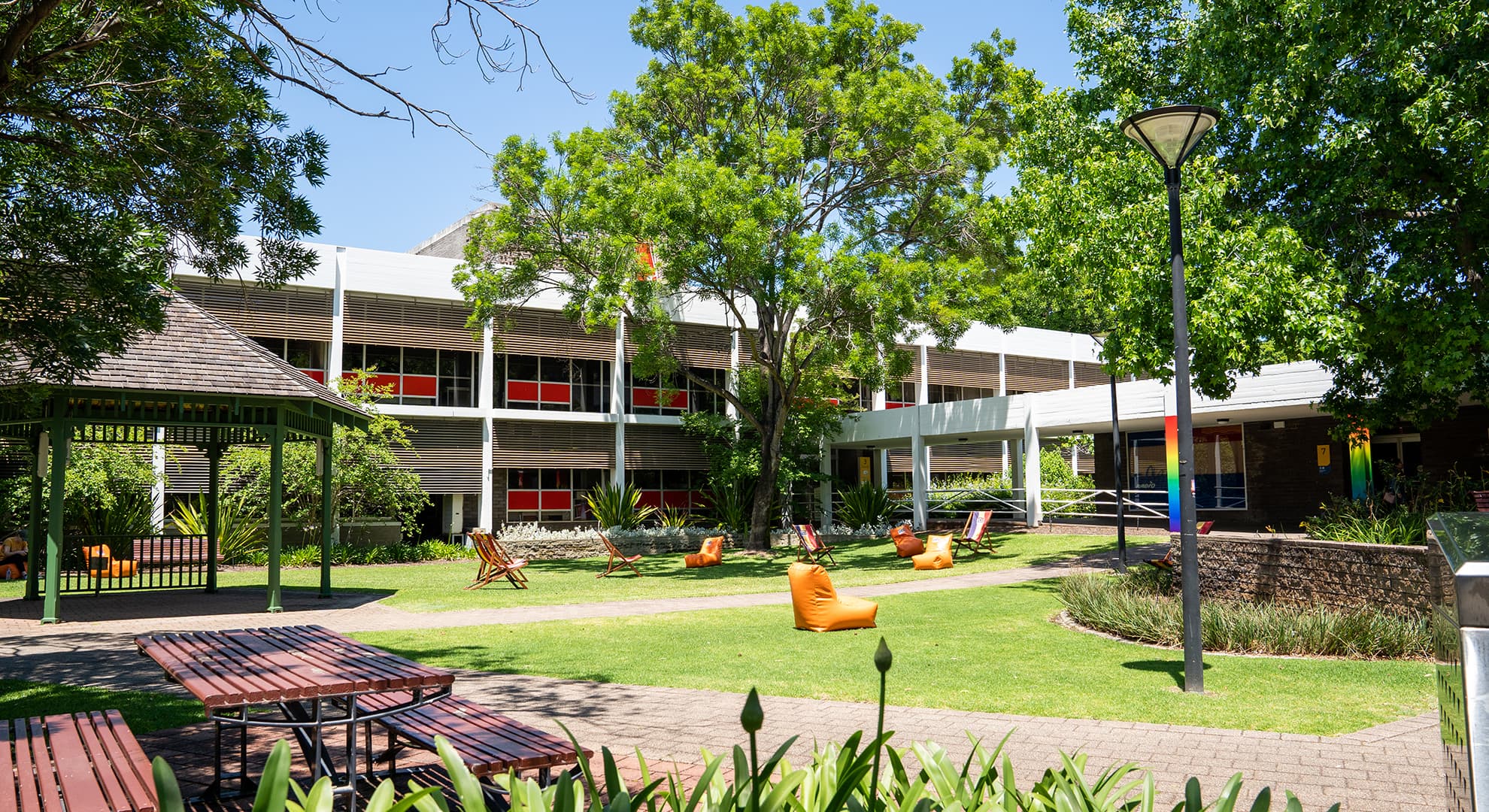 A university campus with buildings, grass and chairs