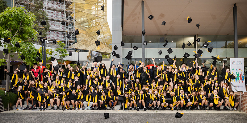 2023 CU Graduates throwing hats Childrens University graduates standing on the steps at ECU Joondalup celebrating and throwing their hats at the 2023 graduation