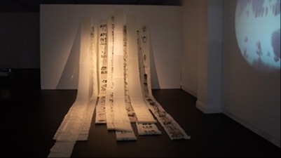 Fabric artwork hanging from gallery exhibition walls