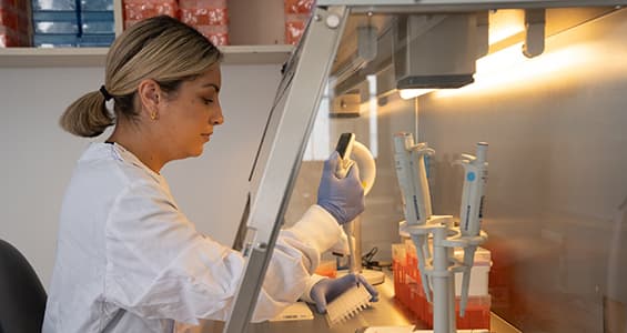 woman in white coat holding a syringe