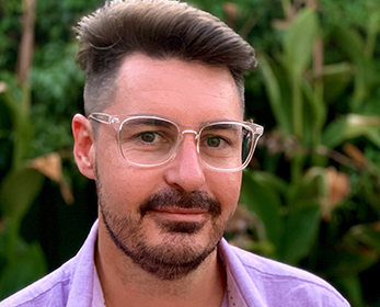 Image of Mr Tee-Jay Scott wearing a purple open shirt