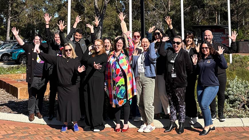 People smiling in a group photo