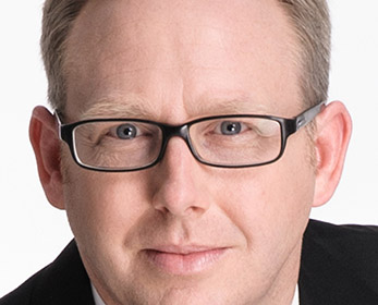 Image headshot of a Professor wearing glasses