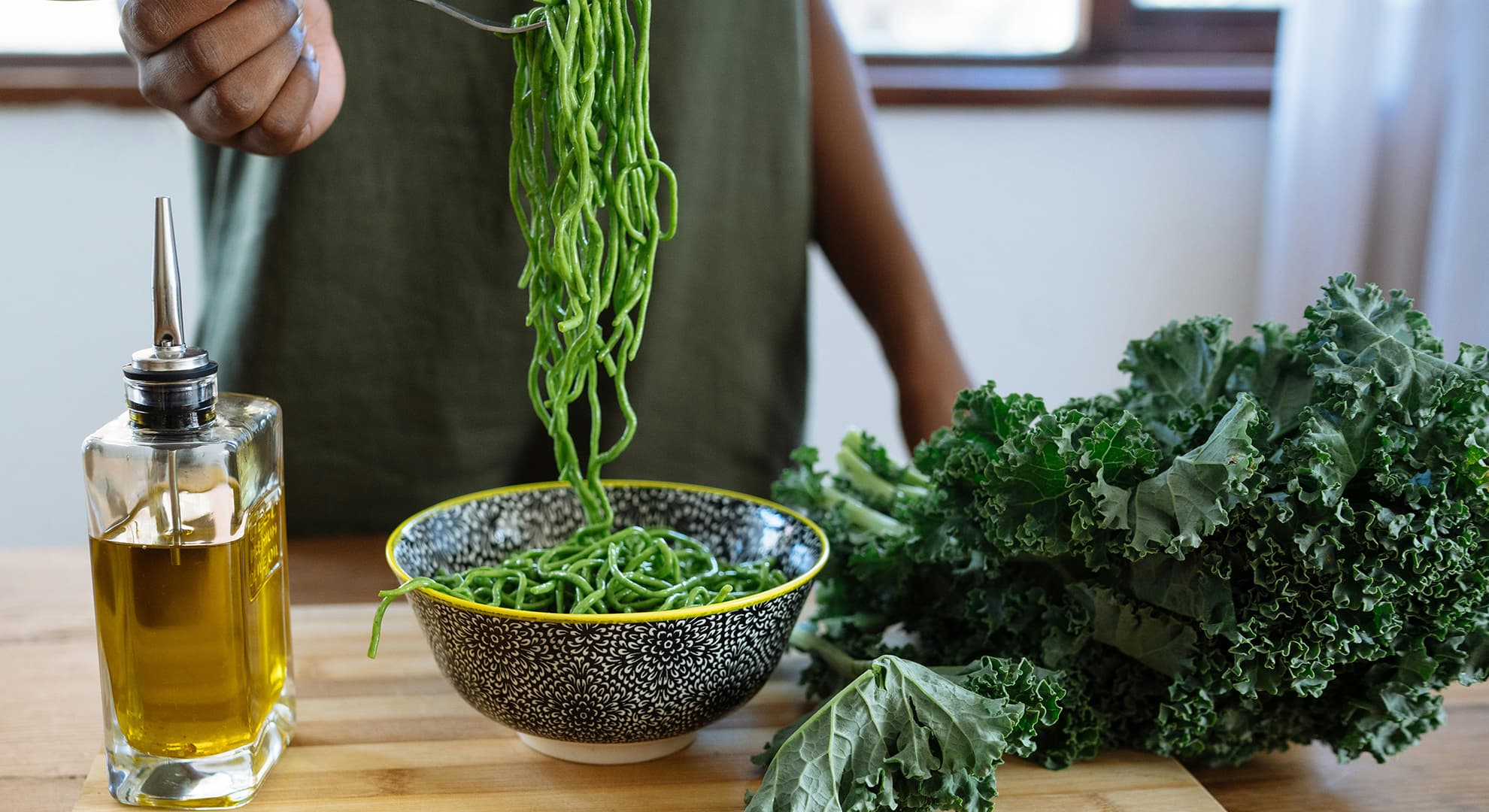 Woman holding green pasta