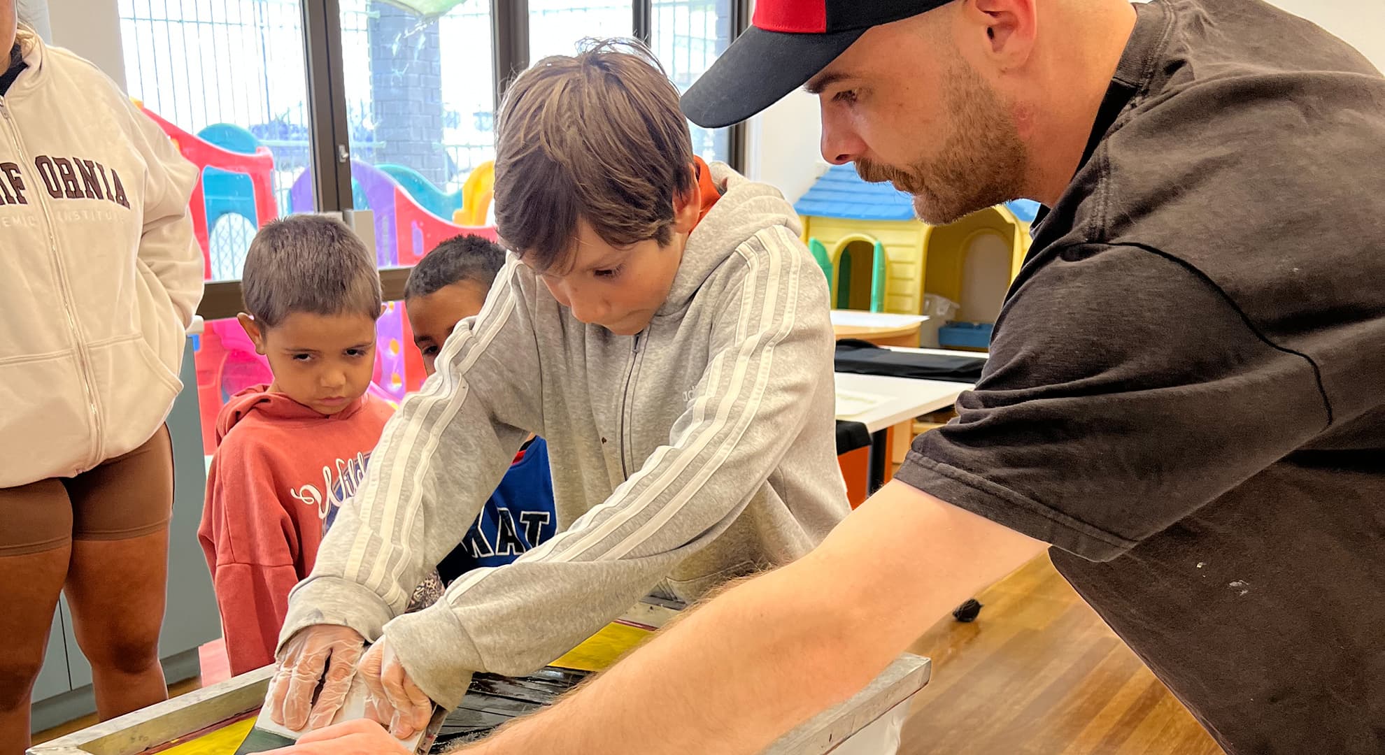 Children with man in an artist's studio