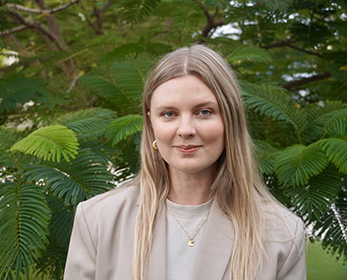 Image of a woman in a beige blazer with long blonde hair