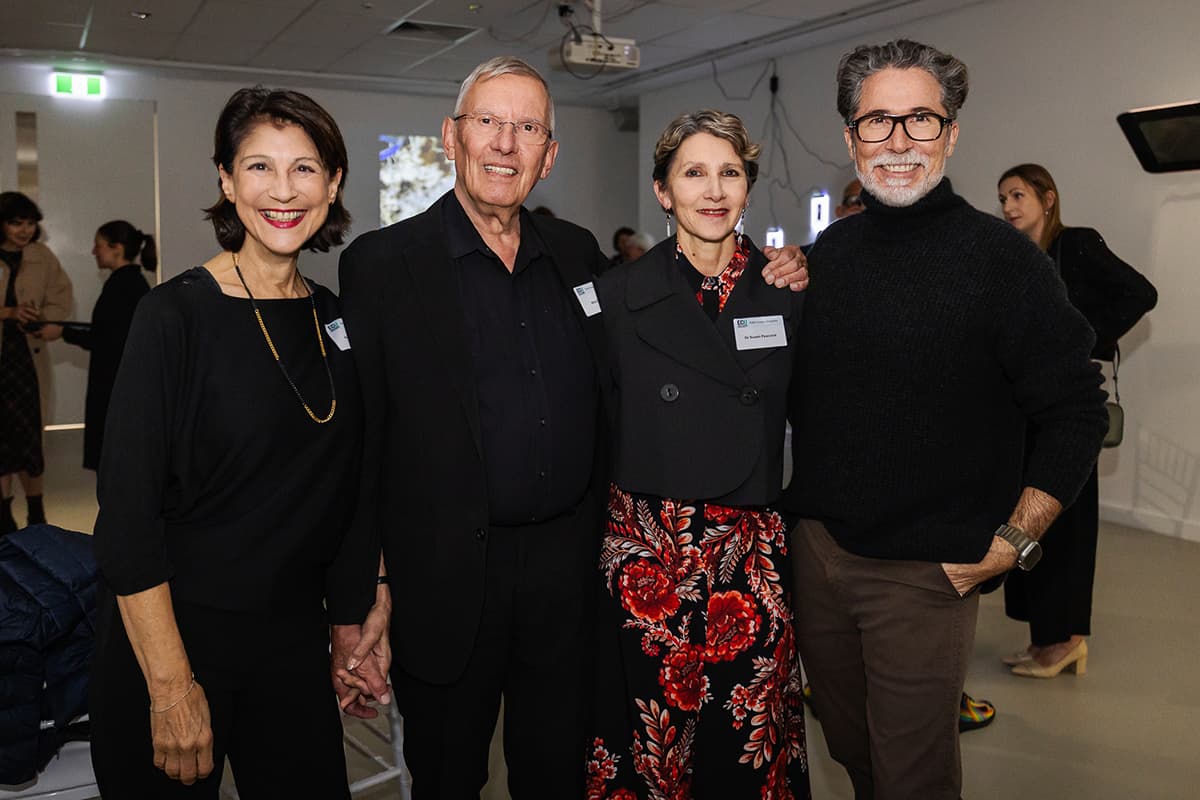 Four people standing in a row