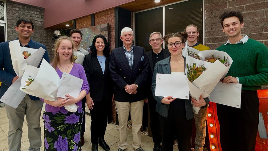 Group of people standing with awards and flowers