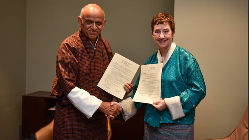 Two people holding certificates