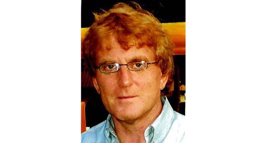 A young man posing for a photo.