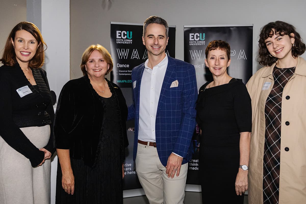 Five people standing in a row