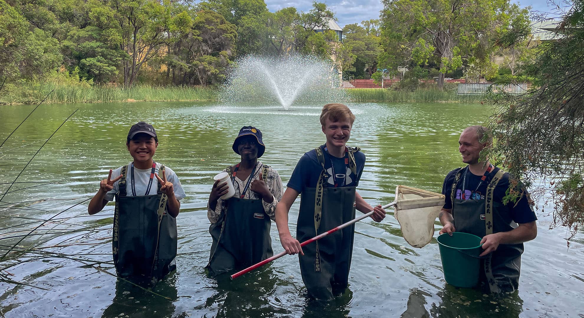 Teenage boys wading in lake