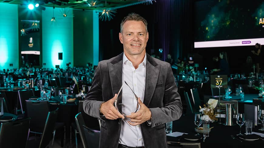 Man standing with award