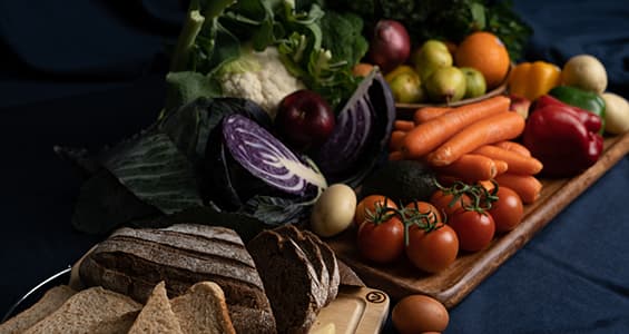 selection of fruit and cheese on wooden chopping board