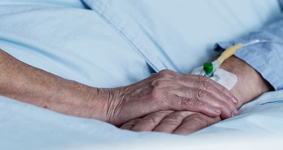 close of up an older person's wrist with a canula inserted.