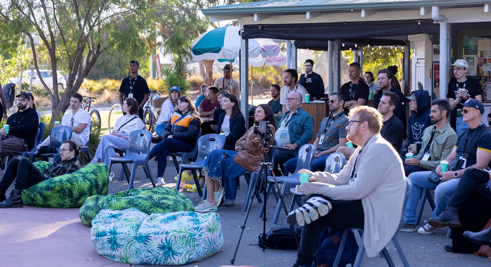 People listening at outdoor conference.