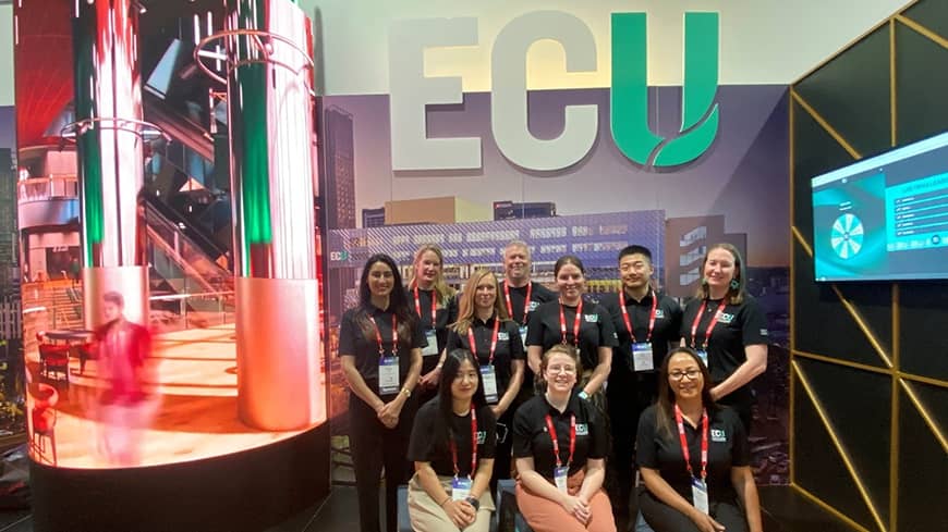 A large group of people sitting and standing for a team photo