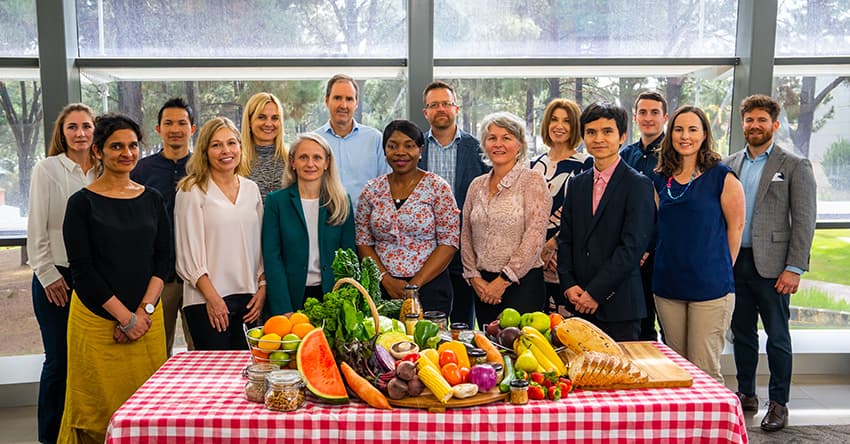 scientist standing behind table full of food