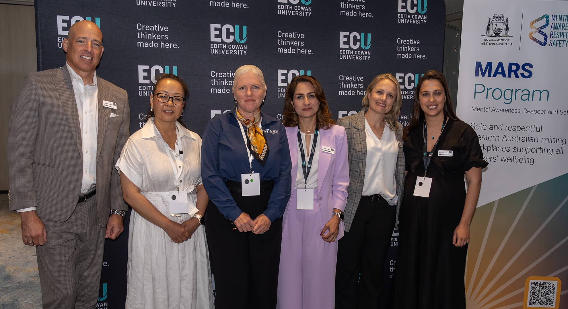 People standing in front of banners.