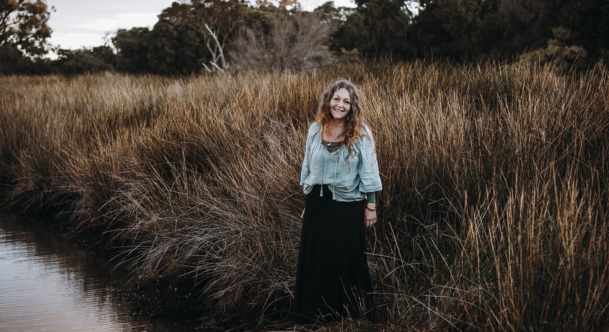 Dr Donna Mazza standing on a riverbank