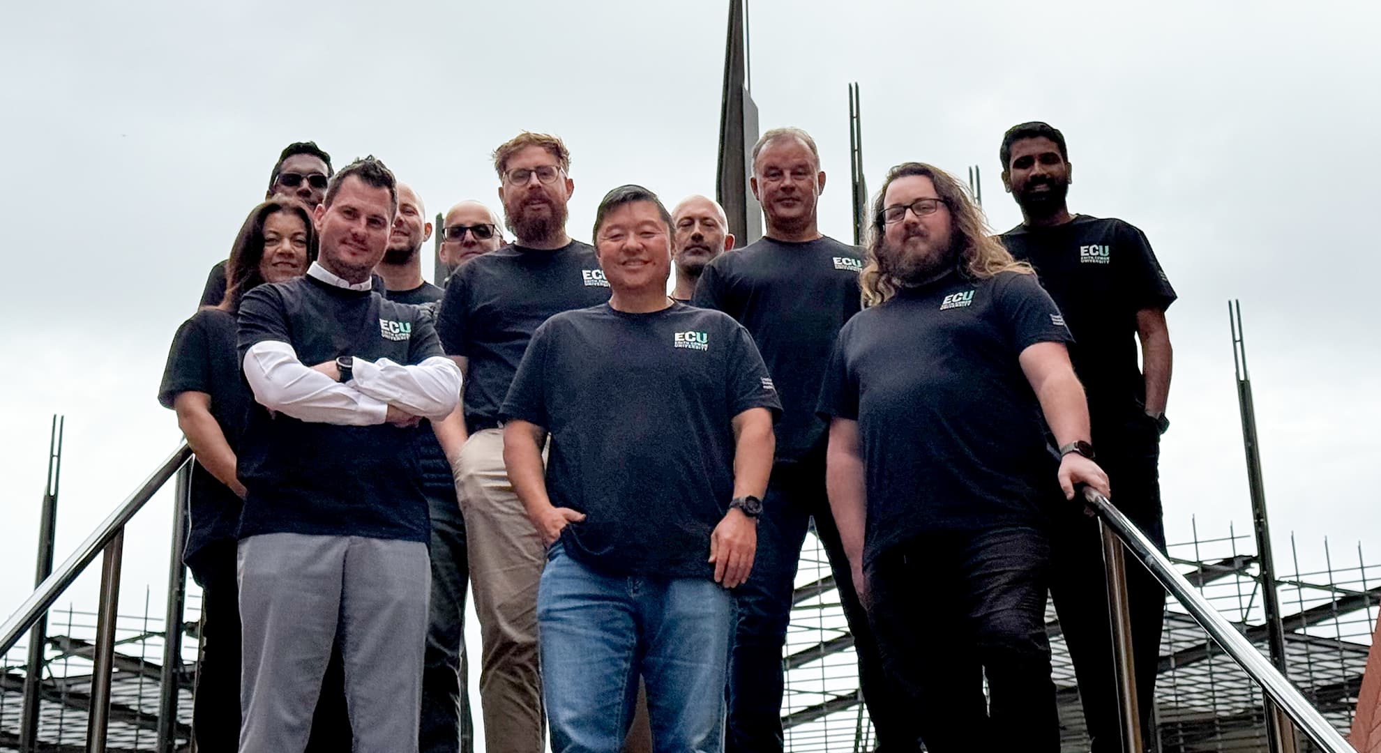 Team members gather on steps