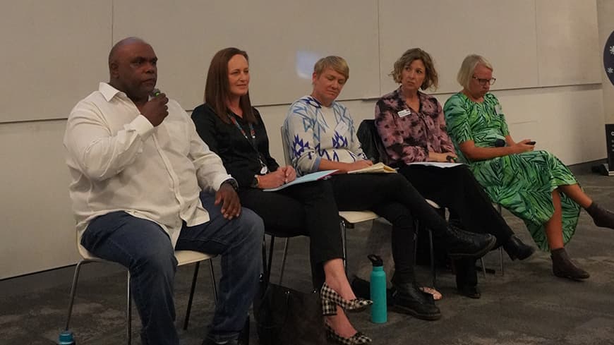 Five academics sit as panellists at the front of the lecture hall, they are discussing mobility justice in relation to place and environment.