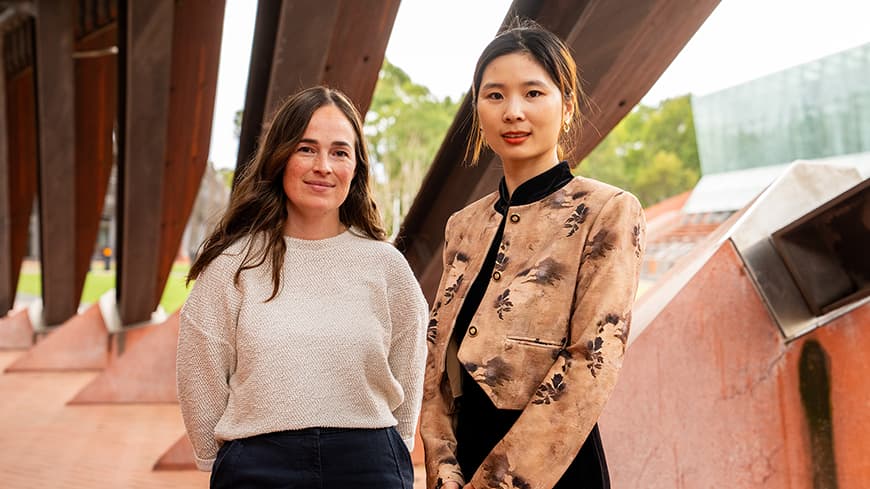 Two people standing next to each other outside ECU Joondalup's main building 1