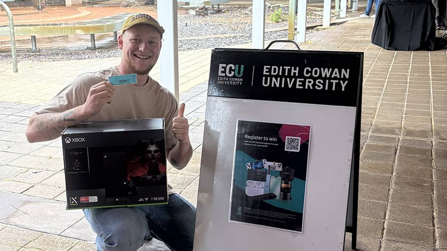 Student winner holding Xbox prize