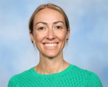 A picture of Mrs Ashley Hetaraka wearing a green top smiling in front of a white background