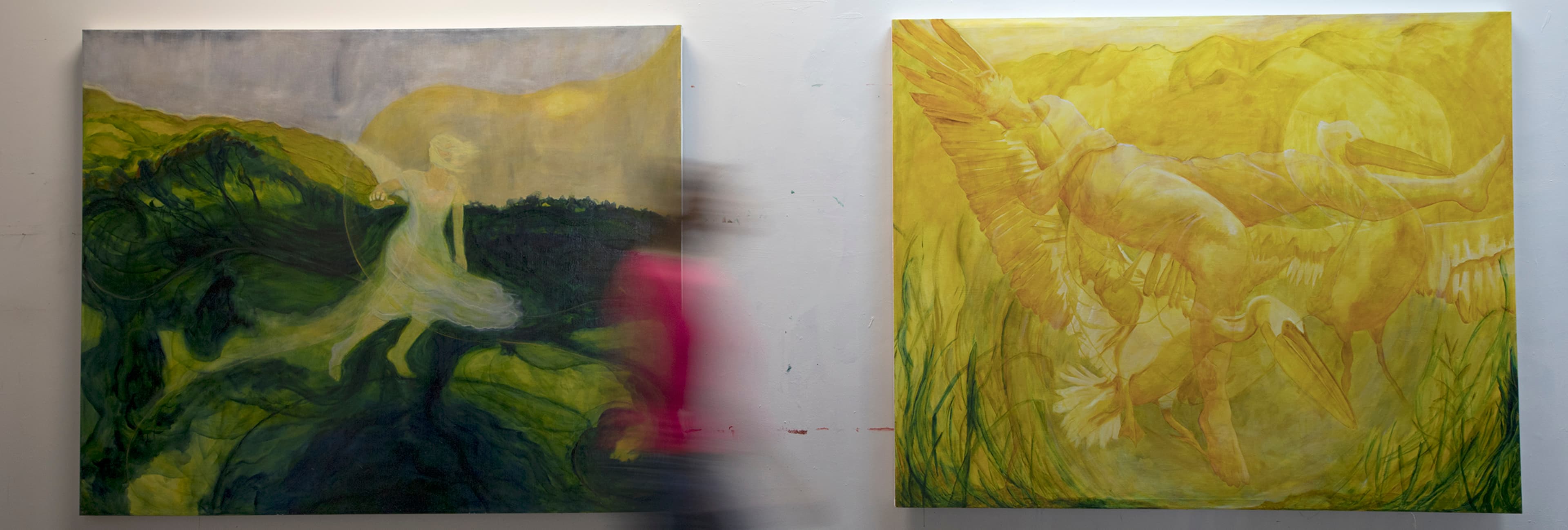 Person walking past 2 painted artworks