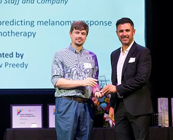 Image of Dr Beasley accepting a grant award at a ceremony