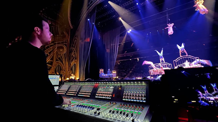 Man working at a sound desk in a musical theatre.