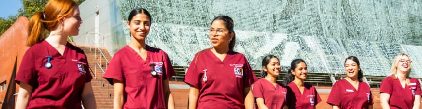 A group of students standing outside a university building