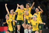 Photograph of a female soccer team jumping in celebration