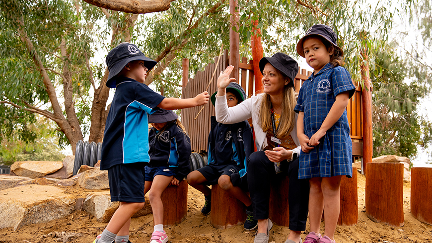 Young female teacher with students