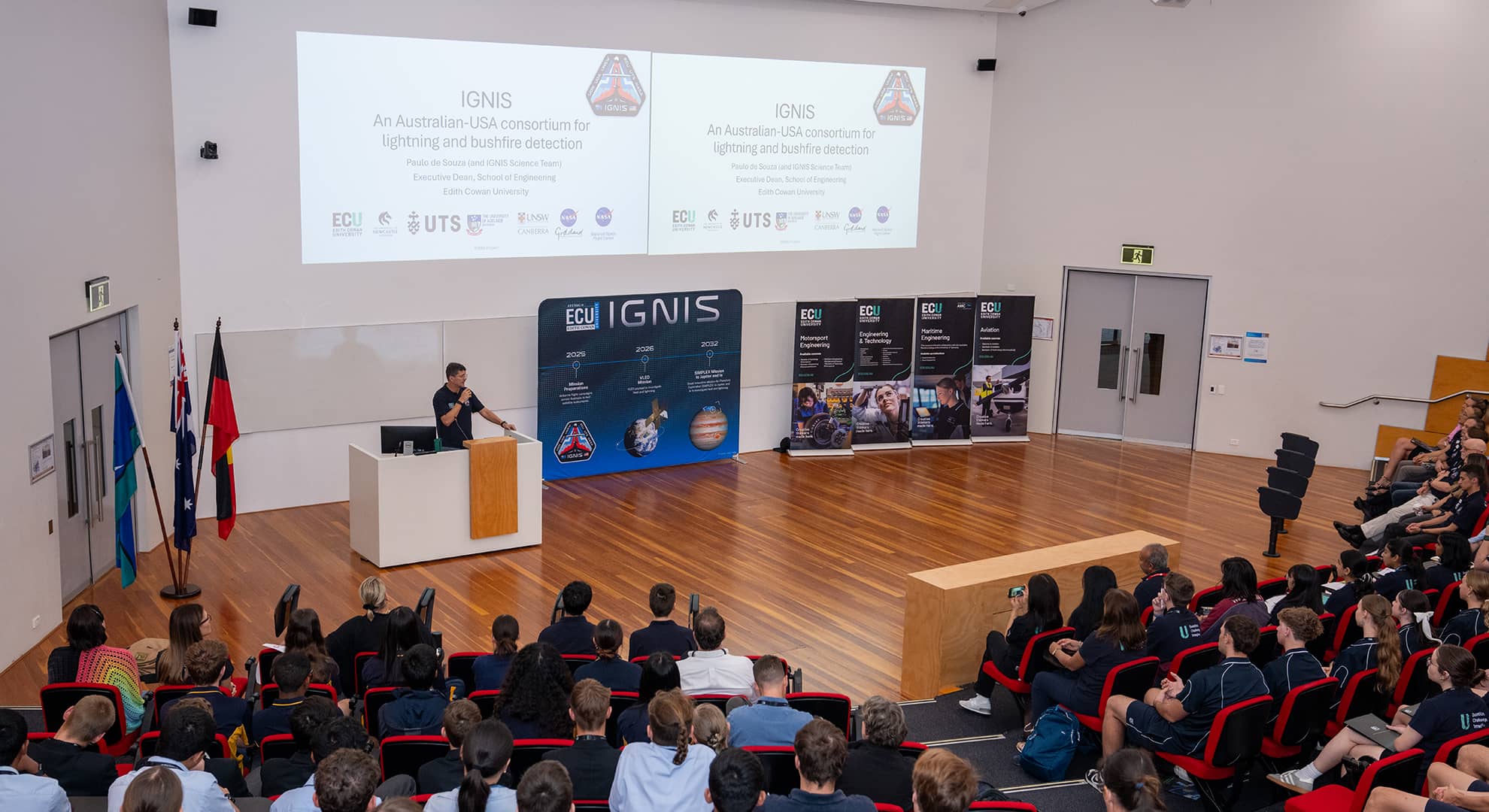 Prof Paulo de Souza surrounded by IGNIS banners standing in front of a crowd.