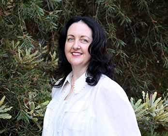 Dr Eibhlish O'Hara smiling in front of a tree