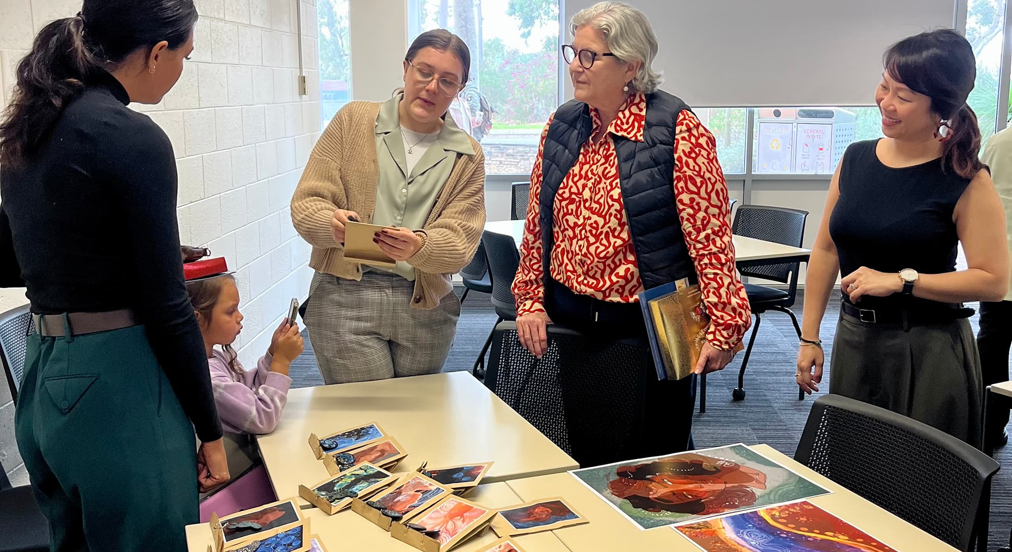 A group of students and their lecture participate in workshops in a classroom.