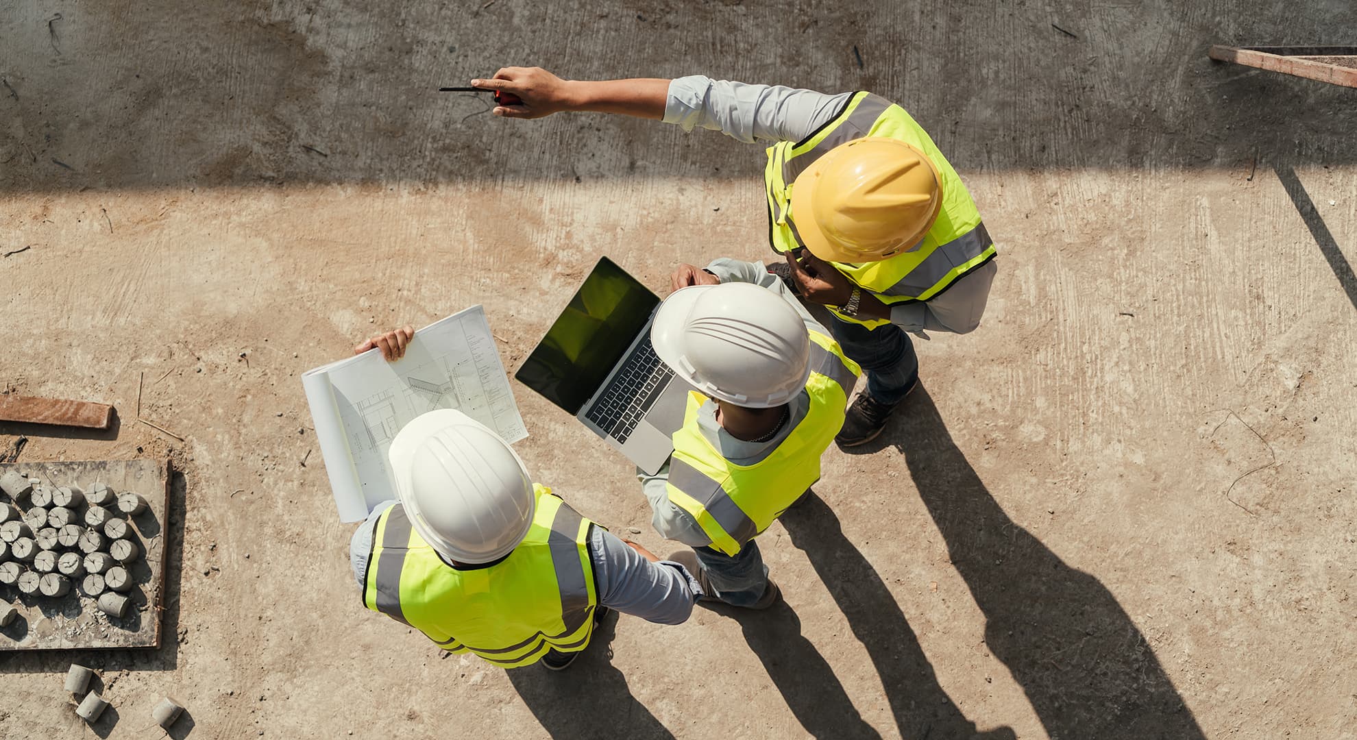 Workers in hard hats on building site