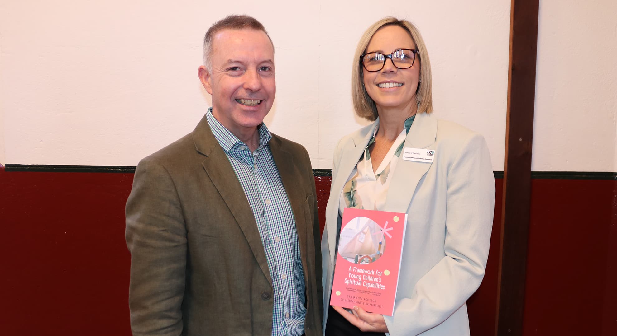 Dr Brendan Hyde and Associate Professor Christine Robinson holding their new book: A Framework for Young Children's Spiritual Capabilities.