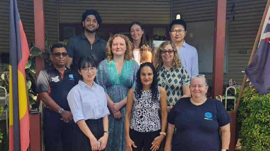 Group of people, some standing on a step behind the others