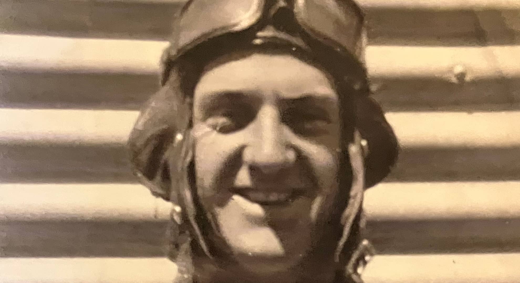 Black and white photo of a man in pilot uniform