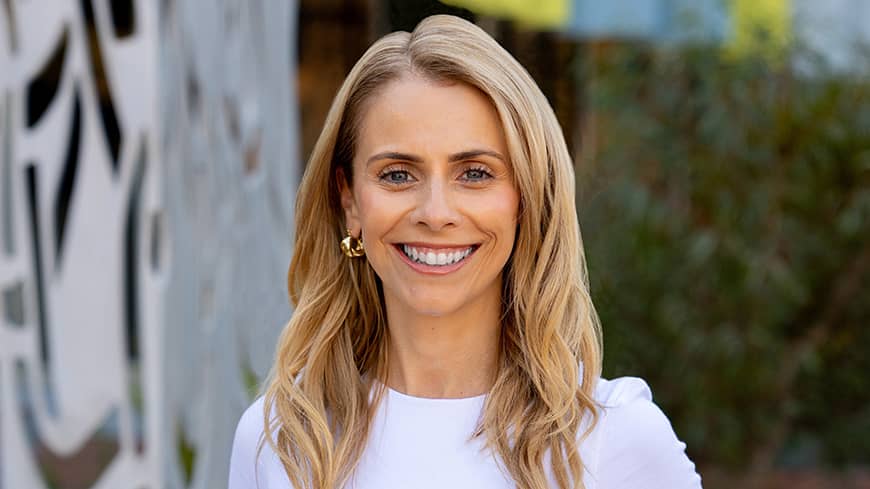 A woman standing in front of a building.
