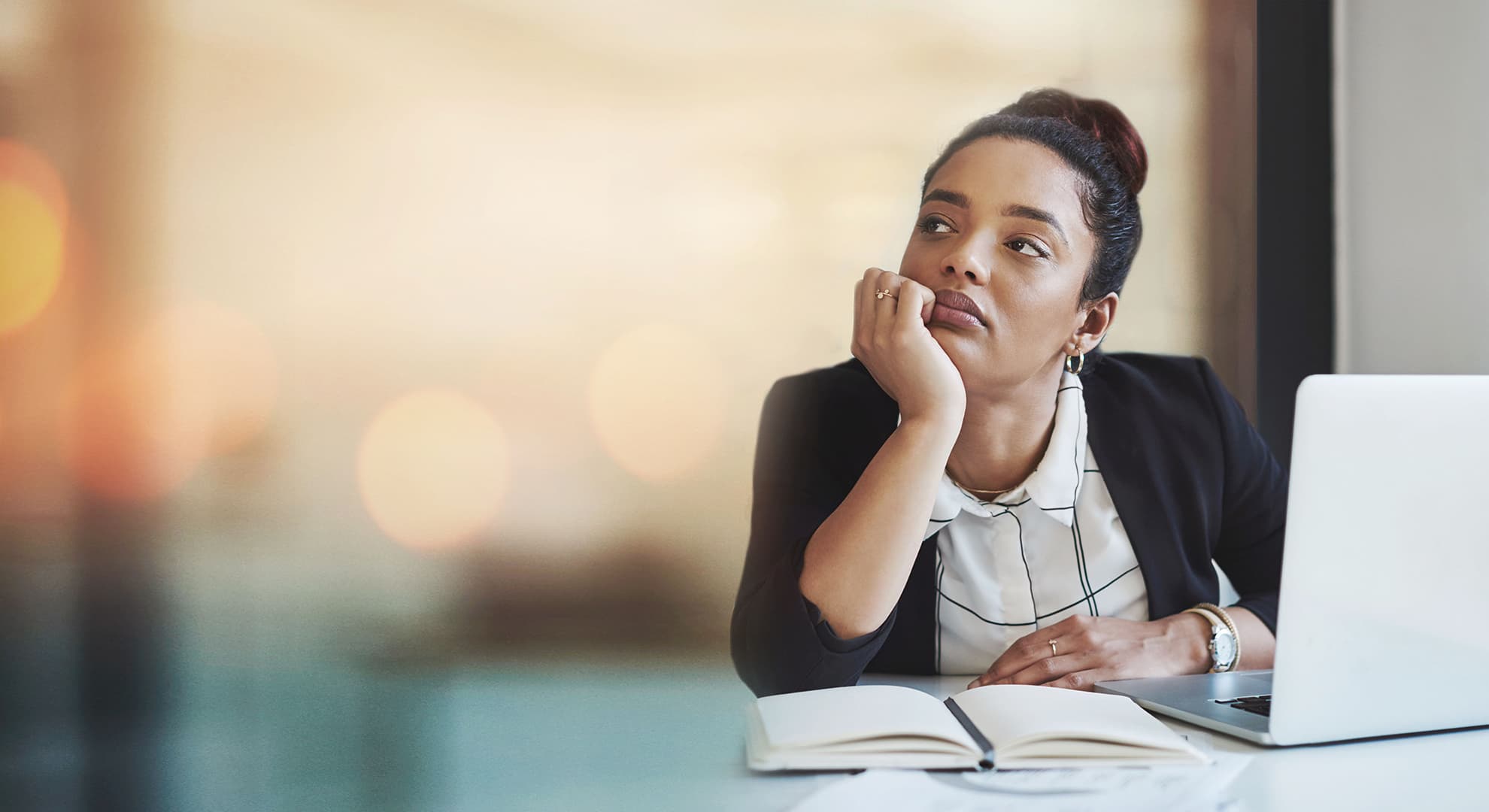 Young woman sitting at desk with laptop.