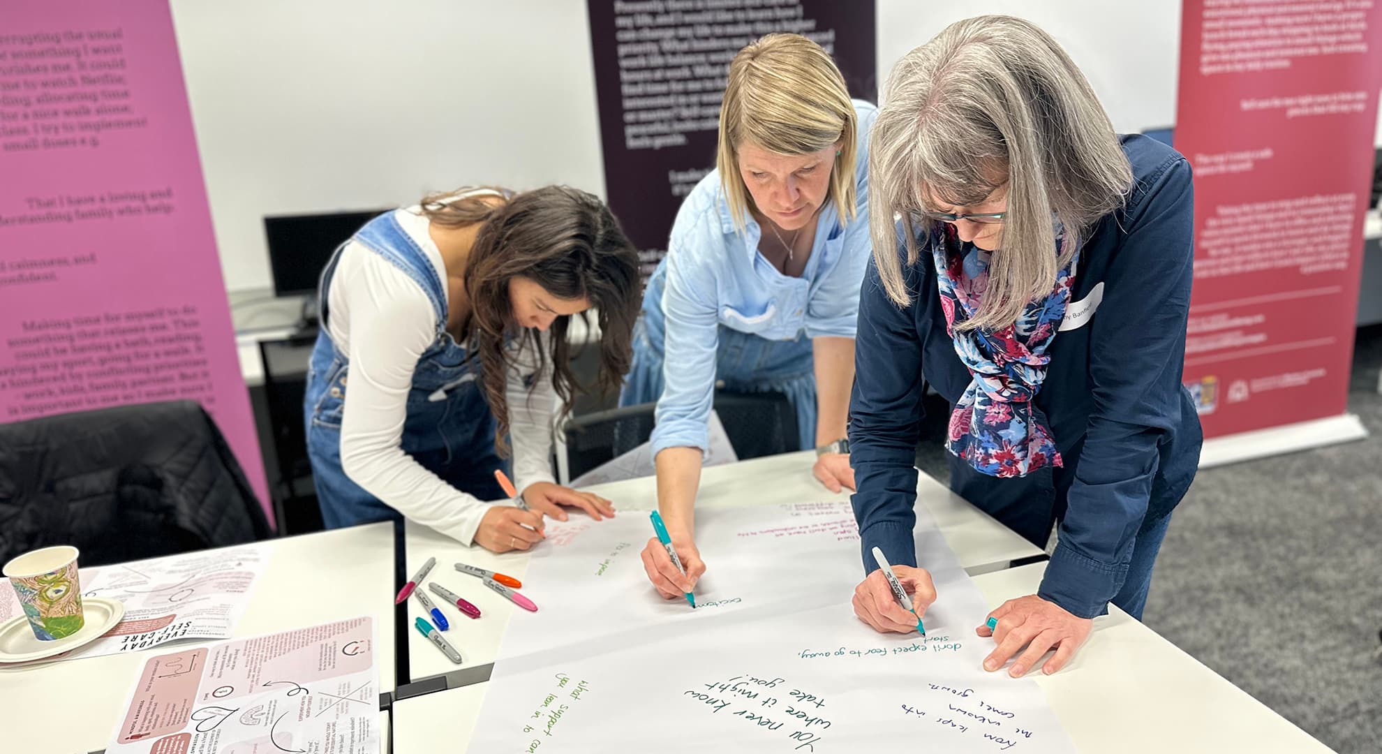 Women writing on banner.
