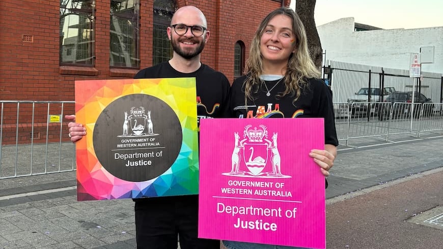 Two young adults standing in a street